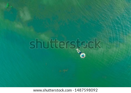 Similar – Aerial view of small boat in sea, copyspace for text