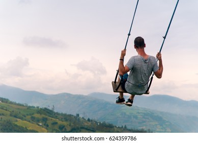  A Person Swing Over The Jungle In Ecuador.