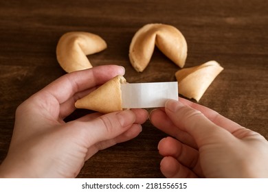 Person taking out blank note with good luck wish from fortune cookie, mockup