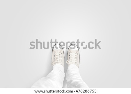 Person taking photo of his foots stand on blank floor, isolated, top view, clipping path. Ground design mock up. Man wear gumshoes and watching down. Deck flooring mockup template.