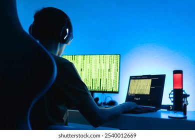 A person in a tech-driven workspace analyzing cybersecurity data on multiple screens, surrounded by neon lights and coding. A futuristic scene depicting digital security and hacking defense - Powered by Shutterstock