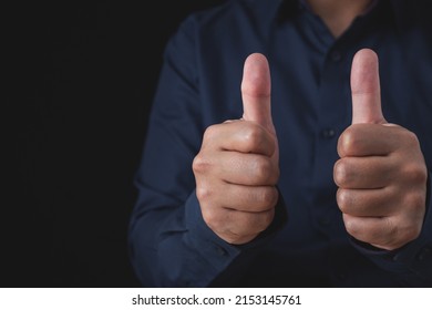 Person that wear dark blue shirt shows thumbs up sign. Salaryman or business man. Like or good concept. Close up shot with copy space. - Shutterstock ID 2153145761