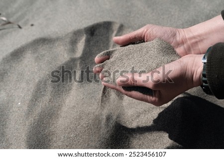 Similar – Hand im Sand Lifestyle