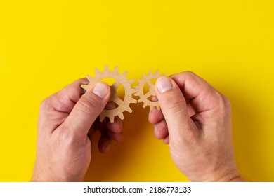 A person tries to assemble two different gears. The concept of creativity, ingenuity, new research, discoveries in science and technology. Invention. Relationships. - Shutterstock ID 2186773133