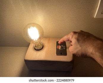 Person Turning Off A Lamp