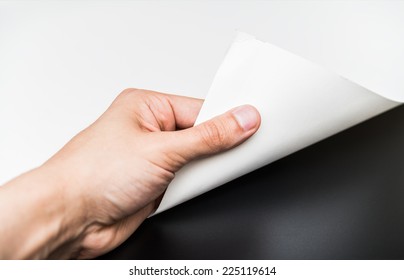 Person Turning The White Page To Reveal A Blank Dark Surface. 