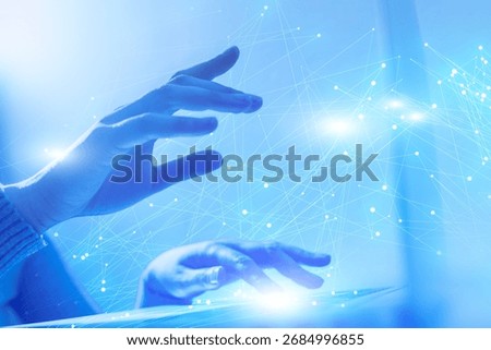 A person is typing on a computer. The screen is blue and has a lot of lines. The person's hands are on the keyboard