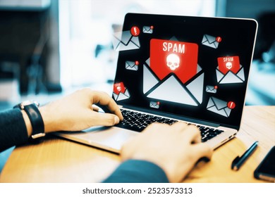 Person typing on a laptop displaying spam email notifications with skull icons, indicating cybersecurity threats and digital protection concepts