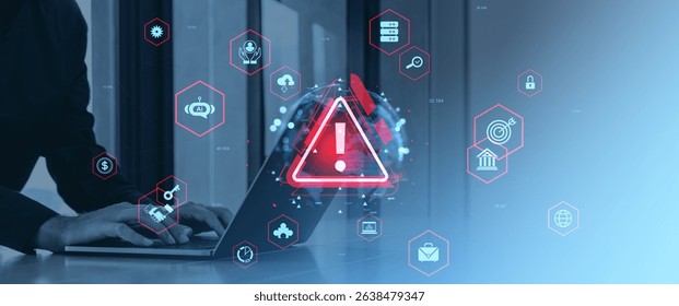 Person typing on laptop with glowing red warning sign and digital business icons overlayed, on a gradient blue background, concept of cybersecurity threat