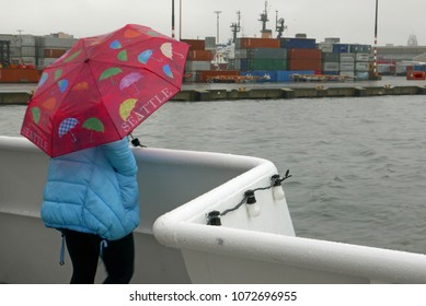 Person With Umbrella On A Boat In Seattle Harbor