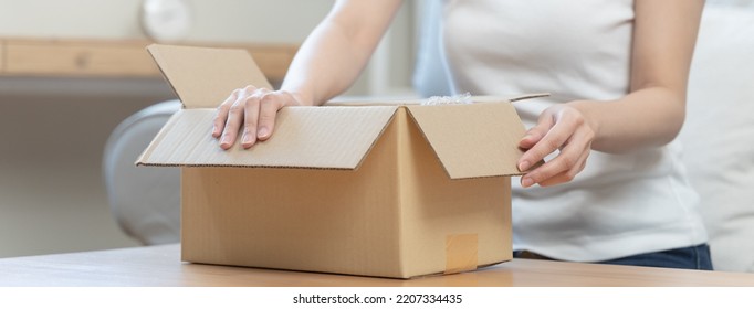 Person Unboxing Package Shopping Online Via Internet At Home