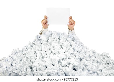 Person under crumpled pile of papers with hand holding a blank page / isolated on white