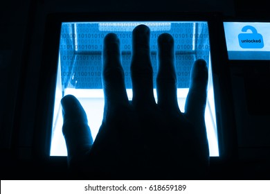 person unlocks a computer on a divice with his fingerprints