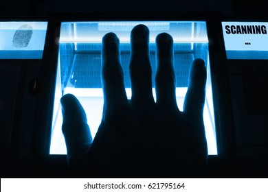 A person uses a fingerprint scanner. Can be used for biometrics or cybersecurity concepts.