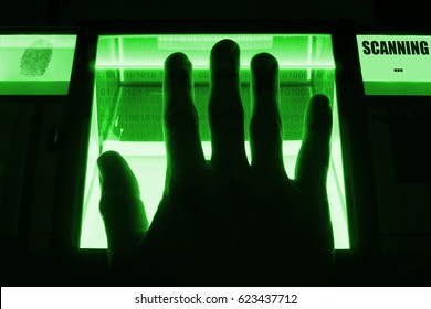 A person uses a fingerprint scanner. Can be used for biometrics or cybersecurity concepts.