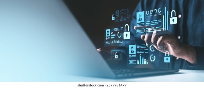 A person uses a laptop with floating holographic icons of locks, data graphs, and user profiles on a dark background. Concept of cybersecurity - Powered by Shutterstock - Get 15% off with code: PIKWIZARD15