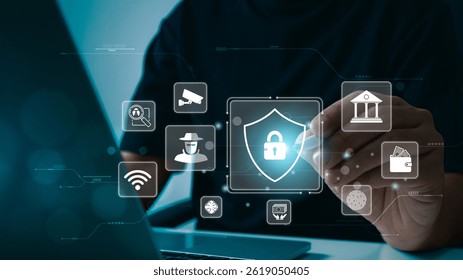 A person uses a stylus and laptop with digital security icons displayed, including a shield with a padlock, symbolizing cybersecurity, data protection, online privacy, and secure financial transaction