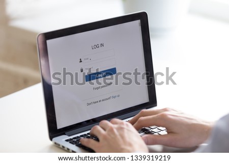 Person using access window to log in or to create new web account. Enter login and password. Cyber protection. Information privacy. Internet and technology concept. Screen close up back view