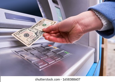 Person Using Automatic Atm Banking To Withdraw Money