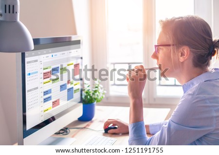 Person using calendar on computer to improve time management, plan appointments, events, tasks and meetings efficiently, improve productivity, organize week day and work hours, business woman, office