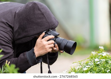 Person using camera taking close up photo of flowers in garden natural light outdoor photography hobby creative focus and artistic lifestyle