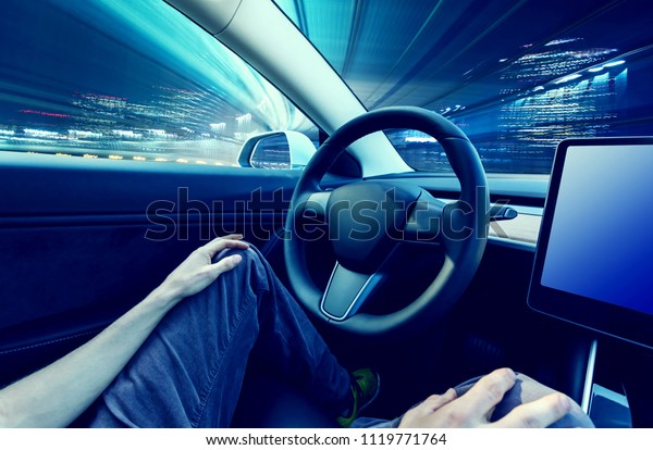 Person using a\
car in autopilot mode hands\
free