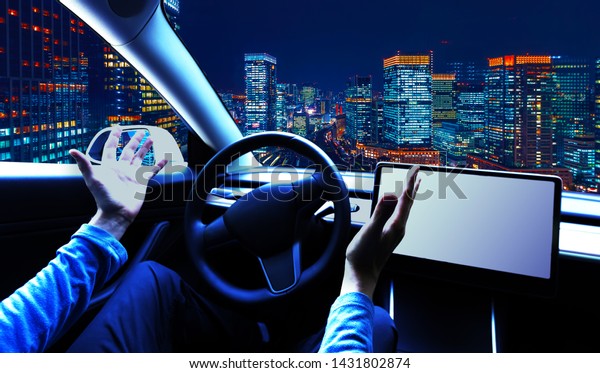Person using a\
car in autopilot mode hands\
free