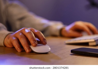 Person using computer mouse and keyboard at desk