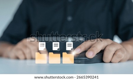 Person using a computer mouse to manage digital folders and verified documents with virtual icons, concept of online file management and data organization