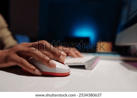 Person Using Computer Mouse at Workspace Desk