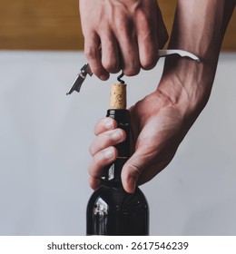 A person is using a corkscrew to open a bottle of wine. The bottle is full of wine and the person is holding it up to the light to see the cork