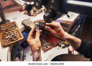 Person using digital caliper for measuring gemstone - Powered by Shutterstock