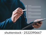 Person using a digital tablet to check items on a virtual checklist. Concept of productivity and task management.