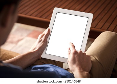 The person using the digital tablet in living room. - Powered by Shutterstock