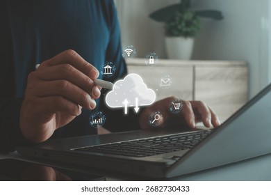 Person using laptop with cloud computing technology icons, concept of data storage, online synchronization, internet security, digital business solutions and cloud services for modern innovation.