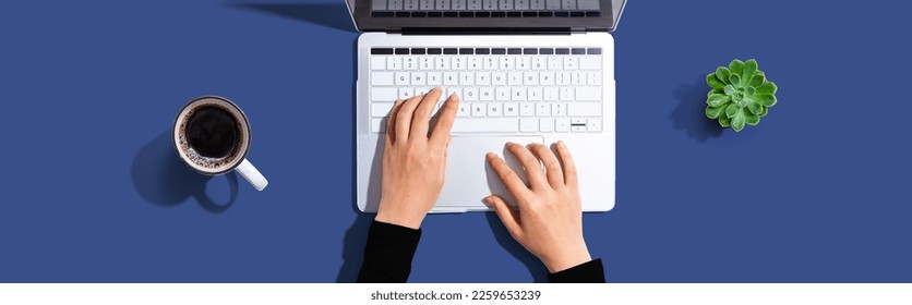 Person using a laptop computer from above
