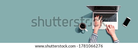 Person using a laptop computer from above