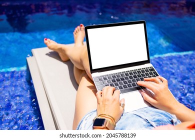 Person Using Laptop Computer By The Poolside