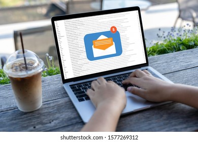 Person Using A Laptop Computer With Email Communication Connection Message Online And Chat On Social Media With Global Letters Concept. Laptop Mockup With Clipping Path On Screen.