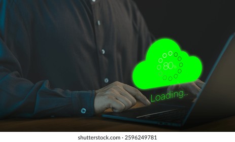 Person using a laptop computer with a glowing green cloud upload icon and loading progress bar, representing cloud computing, data transfer, internet of things, and digital technology.