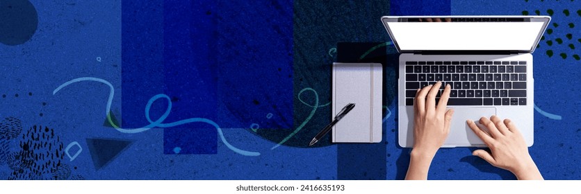 Person using a laptop computer with a notebook - Flat lay