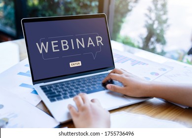 Person Using A Laptop Computer For Online Training Webinars. E-learning Browsing Connection And Cloud Online Technology Webcast Concept. Laptop Mockup With Clipping Path On Screen.