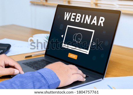 Person using a laptop computer for online training webinars. E-learning browsing connection and cloud online technology webcast concept. Laptop mockup with clipping path on screen.