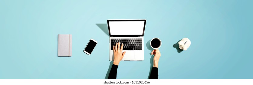 Person Using A Laptop Computer With A Piggy Bank - Flat Lay