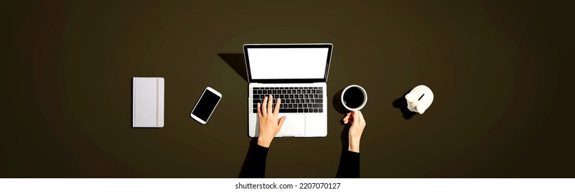 Person Using A Laptop Computer With A Piggy Bank - Flat Lay