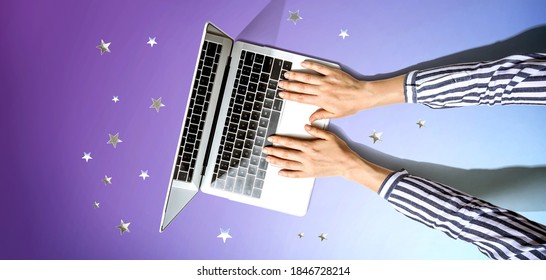 Person using a laptop computer with small stars from above