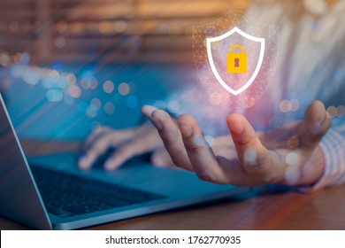 Person using a laptop computer with technology cybersecurity and privacy concept. protection and safe data for global network security. - Powered by Shutterstock