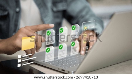 Person using laptop with digital document and folder icons, representing online data management, cloud storage, paperless office, and information technology concept.