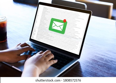 Person Using A Laptop With Email Communication Connection Message Online And Chat On Social Media With Global Letters Concept. Laptop Mockup With Clipping Path On Screen.