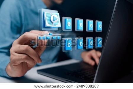 A person using a laptop with an interactive e-book interface showing various media options. The image emphasizes digital reading, multimedia content, and modern technology in education.